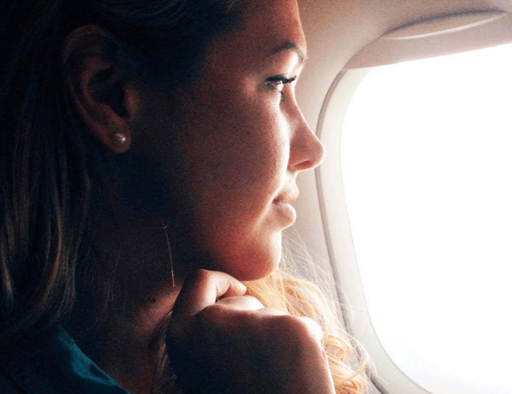 Chelsea looking out airplane window