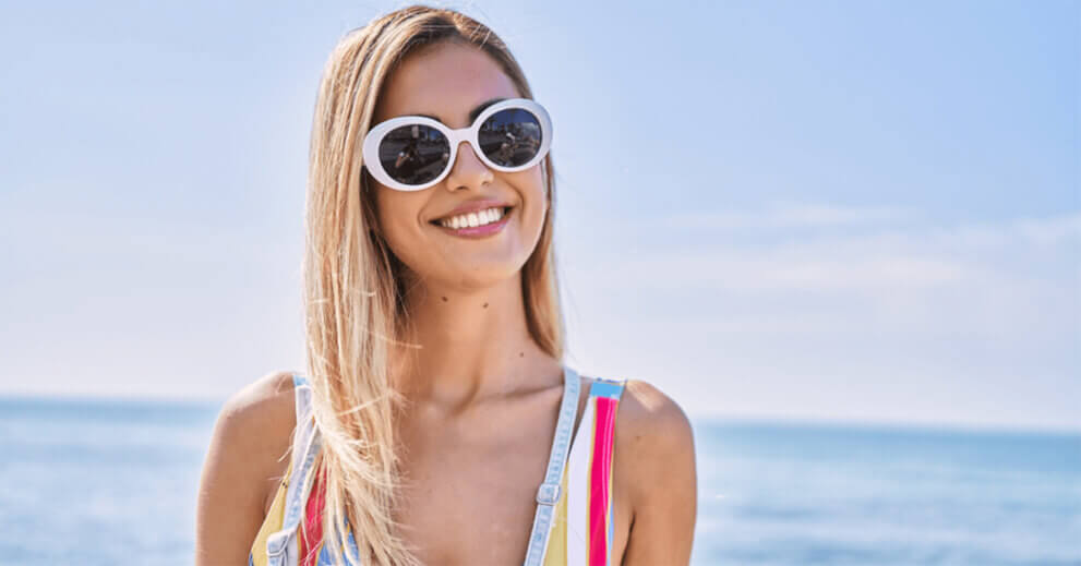 Woman on beach in sunglasses