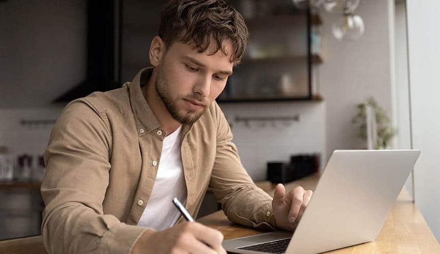 Man Doing Research on His Laptop Computer